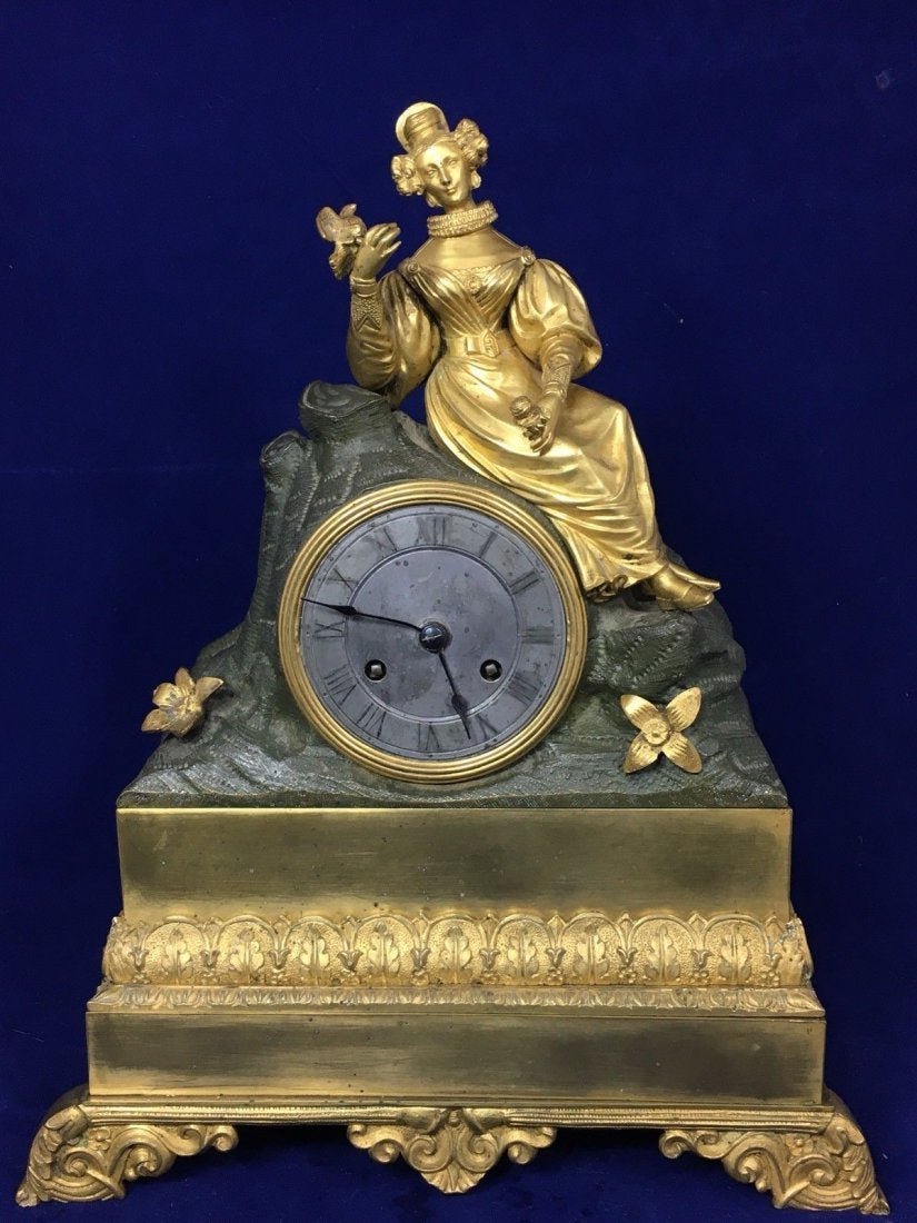 French Gilded Dore Ormolu Bronze Clock Early 19th C: French Gilded Dore Ormolu Bronze Statue Clock Early 19th Century.Lady&Bird Missing pendulum, small tiny hole on the top. Not sure about the working condition.beautiful piece. We don’t guarantee the 