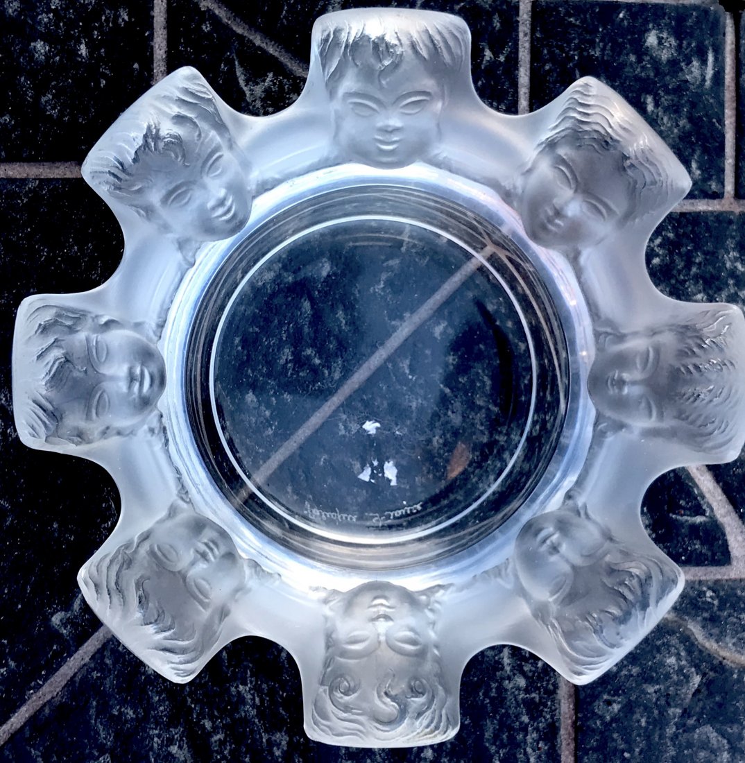 Signed Lalique Ashtray OF cherub faces 4 1/2" Diameter: Signed Lalique Ashtray OF cherub faces 4 1/2" DiameterSigned int he bottom.Excellent vintage conditionLocal shipping cost is $25