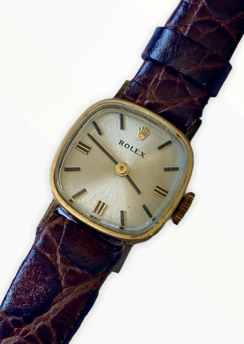 Vintage petite 14K Yellow Gold Ladies Rolex with original Rolex crown, and buckle: Small watch measures approximately 17mm in width. The new old stock Rolex band will fit up to 7” wrist size. Hand winding with Original Rolex movement which is is in running co diction. Also com