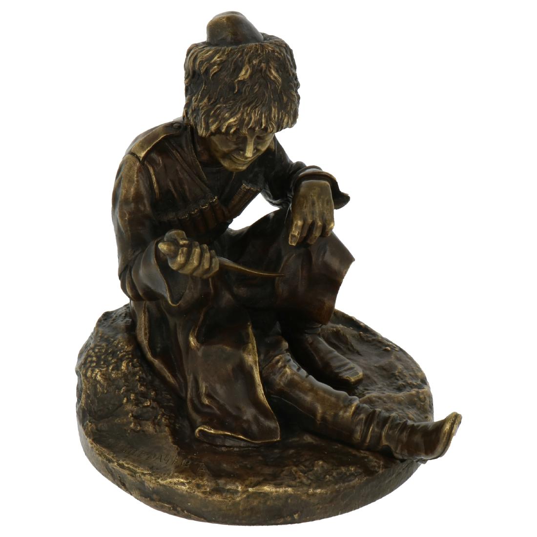 A sitting young Cossack with curved dagger.: Bronze. Signed in the foot "Fabr. C. F. Woerfell St. Petersburg" and with watering stamp. 19th century. 11 x 9.5 cm.