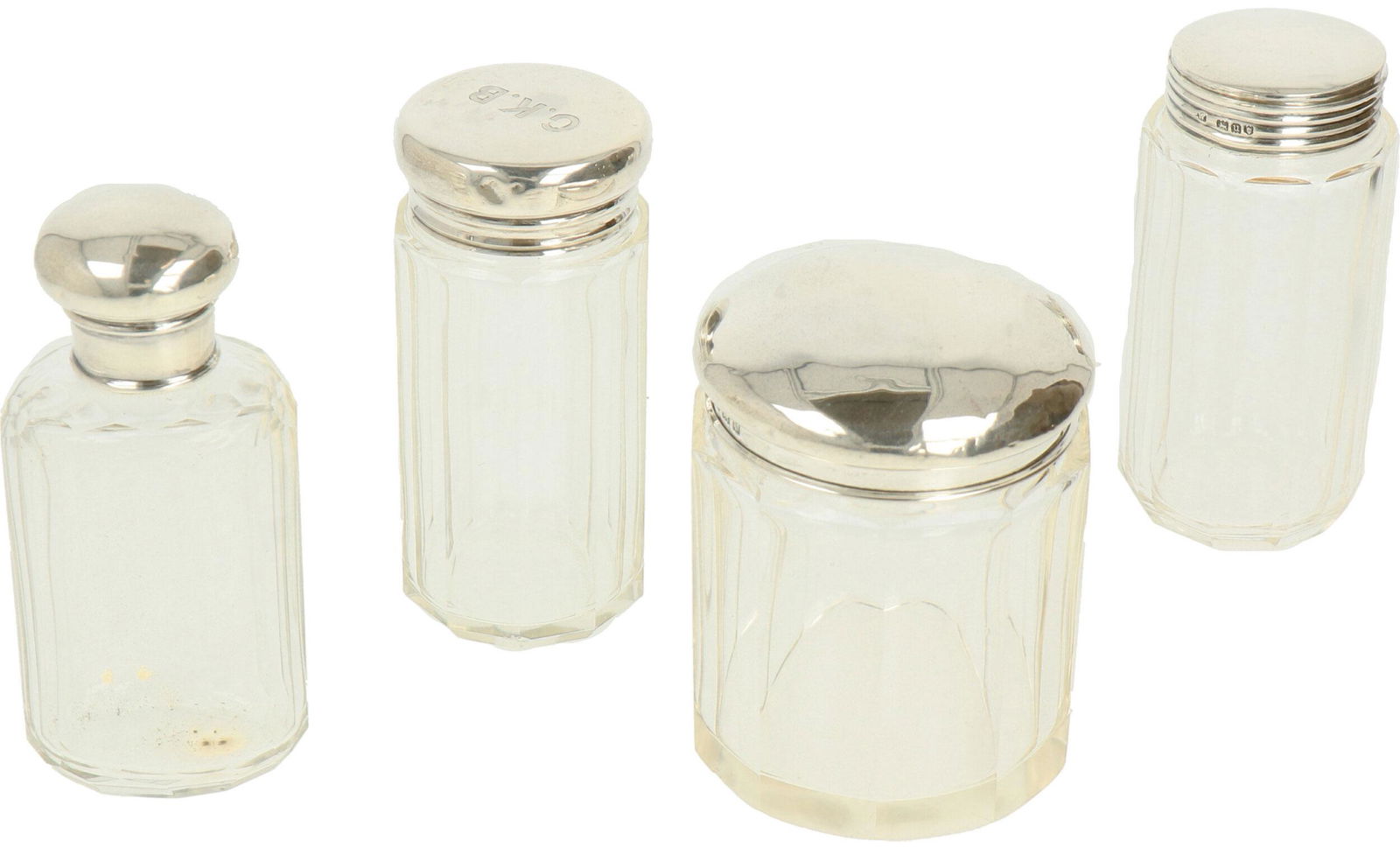 (4) piece set Dressing table vials silver.: Crystal flasks with silver caps. England, London / Birmingham, early 20th century, Hallmarks: various marks. 40 grams, 925/1000.