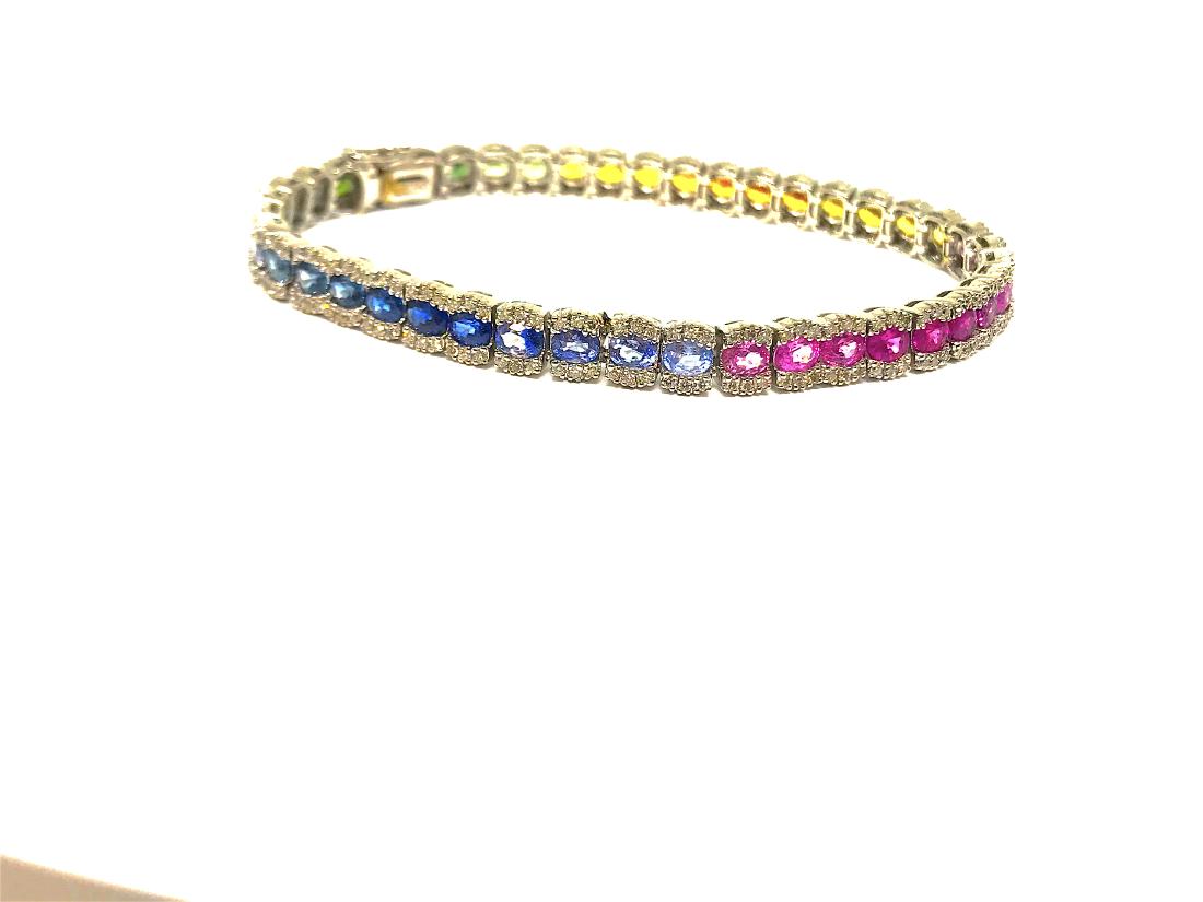 18k Rainbow Bracalet/Diamonds: This gorgeous bracalet is one of a kind, it contains different natural stones such as, Sapphire, Tanzinite, aquamarine and moreâ€¦ Total of 43 natural colored stones. Plus diamond around them whic