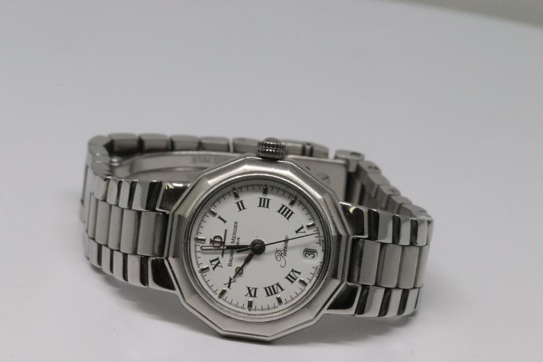 Baume & Mercier Lady's Watch: A Baume & Mercier lady's watch. The watch is stainless steel with a date. # MV040078. Watch measures approx 20mm. The watch had been reciently serviced. White dial, Swiss Made. This is a pre-owned wat