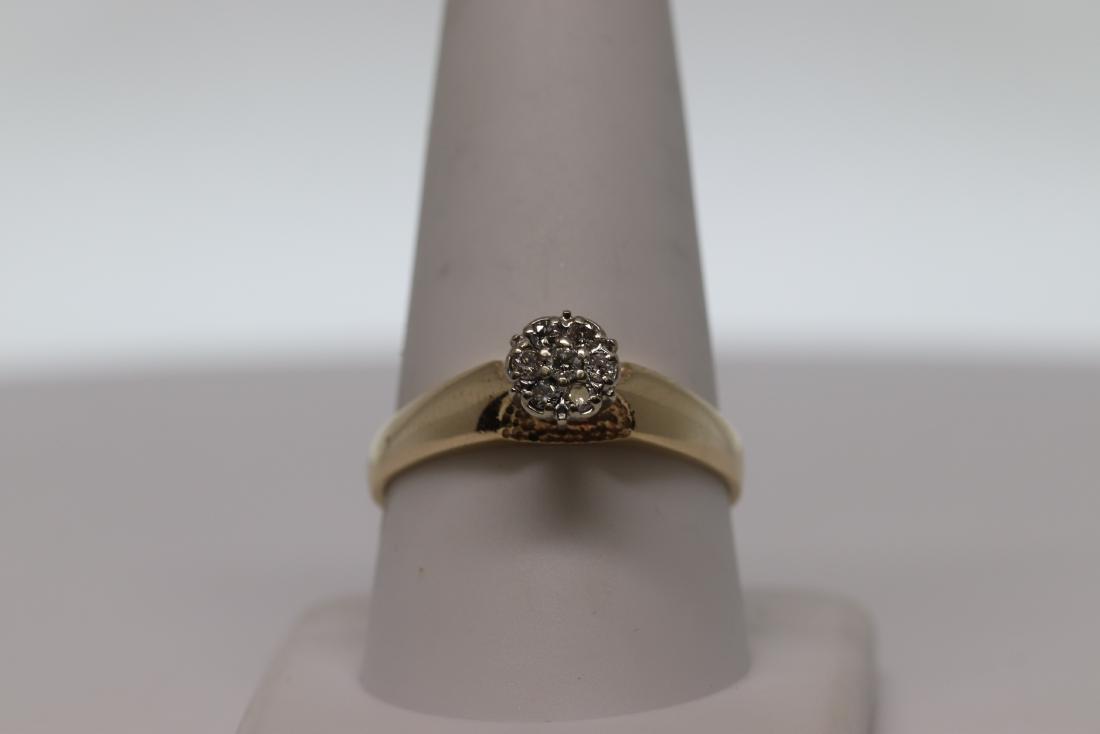 Lady's Diamond Ring: Beautiful 14 karat yellow diamond ring with a total of 7 round brilliant diamonds. Diamonds weights approx 0.15tcw. Ring size is 10mm and weights 3.6g.