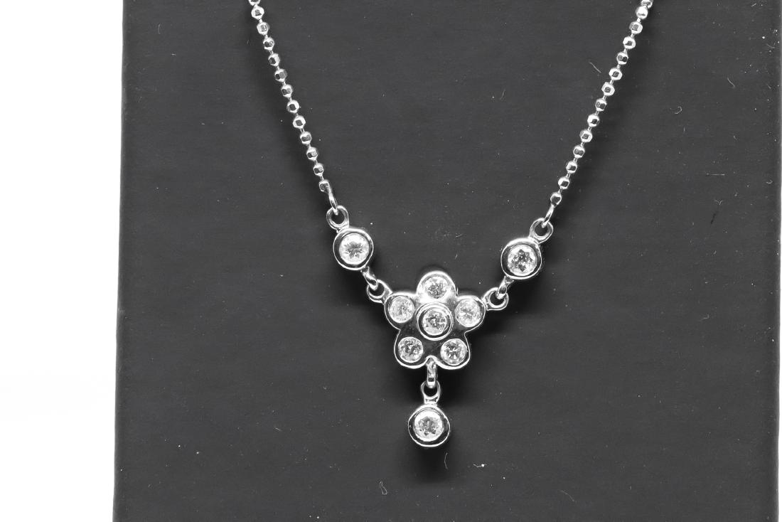 14k Daisy Diamond necklace: 14k white gold diamond "Daisy" necklace., 9 diamonds., marked 14k. Total weight is 4.6g.