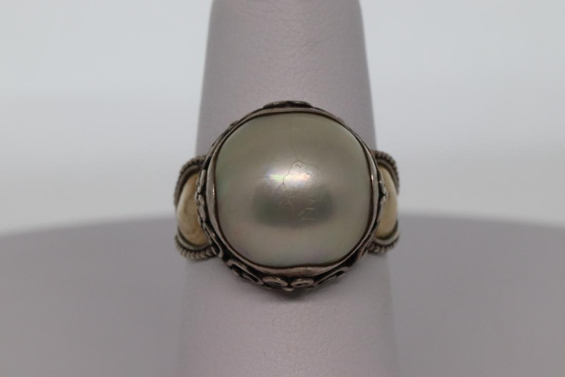 18Kt/Silver Milo Pearl ring: Beautiful 178Kt/ Silver Milo Brand Ring. The ring has a Pearl in the center. Ring size is 7mm. Total weight is 7g.