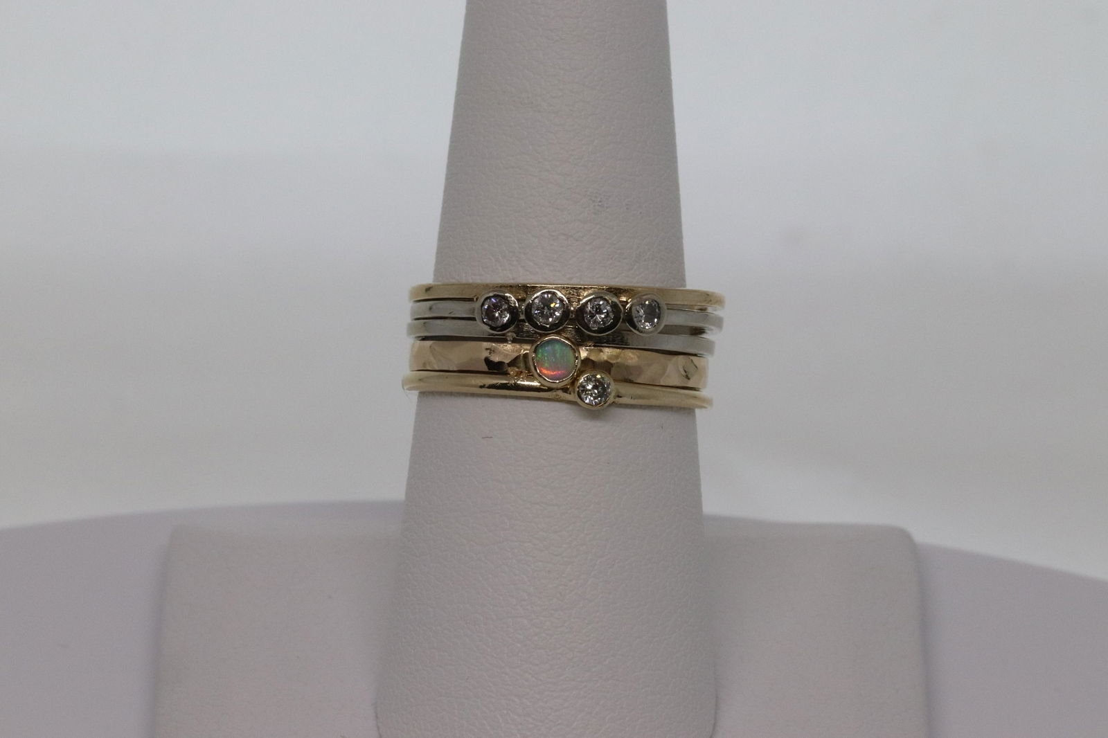 14kt Diamond Stackable Rings: A beautiful 14kt yellow gold with diamonds and Opal stones. These stackable rings are attached together and the diamonds are set in the center. There are a total of 5 round brilliant diamonds and a Ro