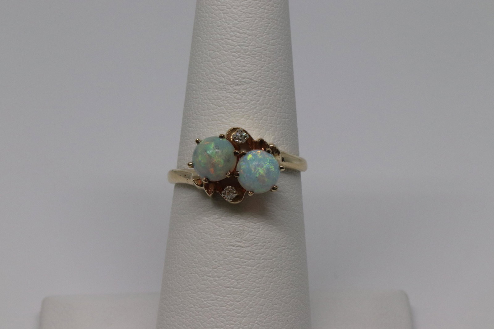 Opal & Diamond Ring: A beautiful 10kt yellow Diamond ring with 2 Round Opal's. the ring has a total of 2 round brilliant diamonds. The ring size is 6.50. SKU02K11Z