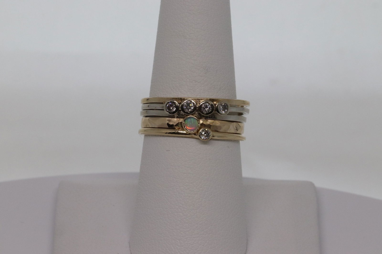 14kt Diamond Stackable Rings: A beautiful 14kt yellow gold with diamonds and Opal stones. These stackable rings are attached together and the diamonds are set in the center. There are a total of 5 round brilliant diamonds and a Ro