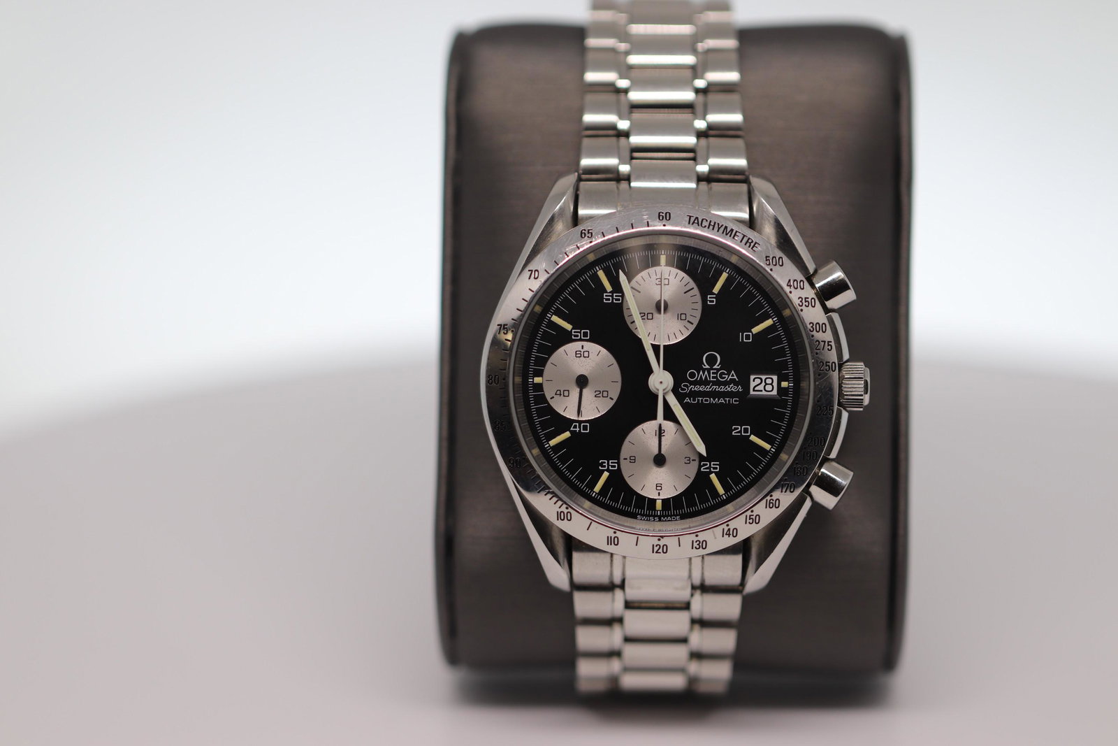 Omega Speedmaster Date Stainless Steel Automatic: Manufacturer's Reference #35115000 Collection: Speedmaster Gender: Men's Circa: 1990s Case Shape: Round Case Size: 39 mm diameter Case Thickness: 14 mm Case Material: Stainless Steel Crystal: Sapphire