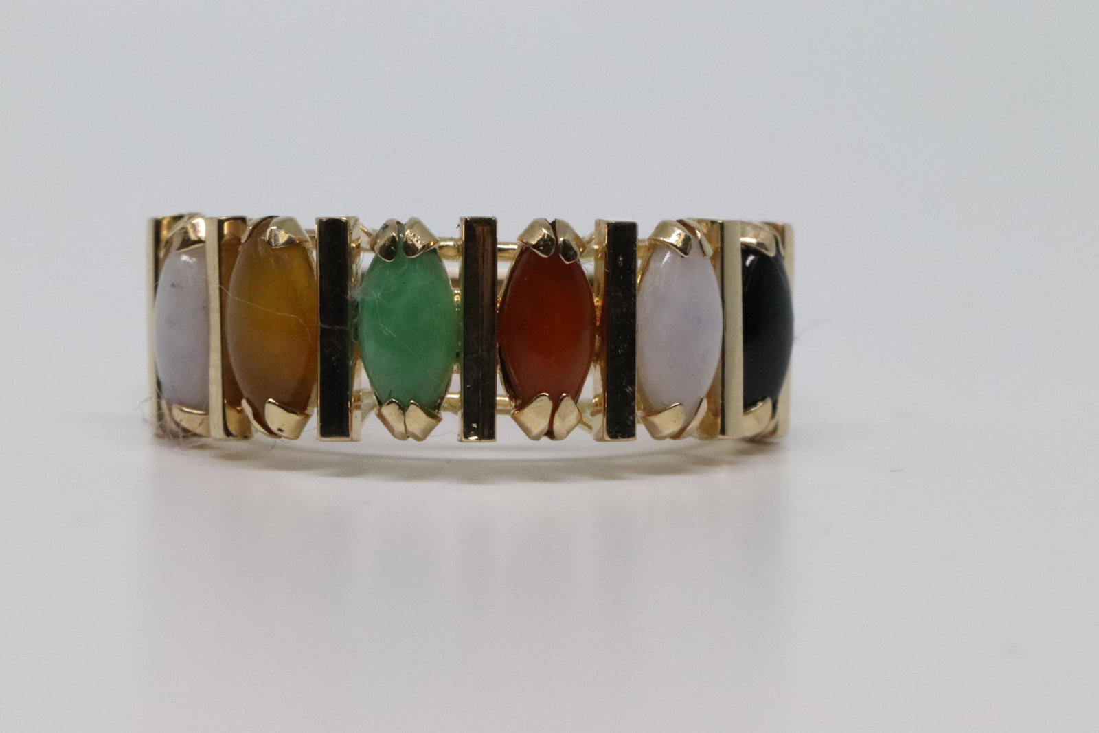 14kt Art Deco Ring: A beautiful multi color Art Deco Ring. The ring has Jade,Onyx and more colored. Total stones are 6 marquise shape stones. Ring size is 6.00. SKU03YSH1
