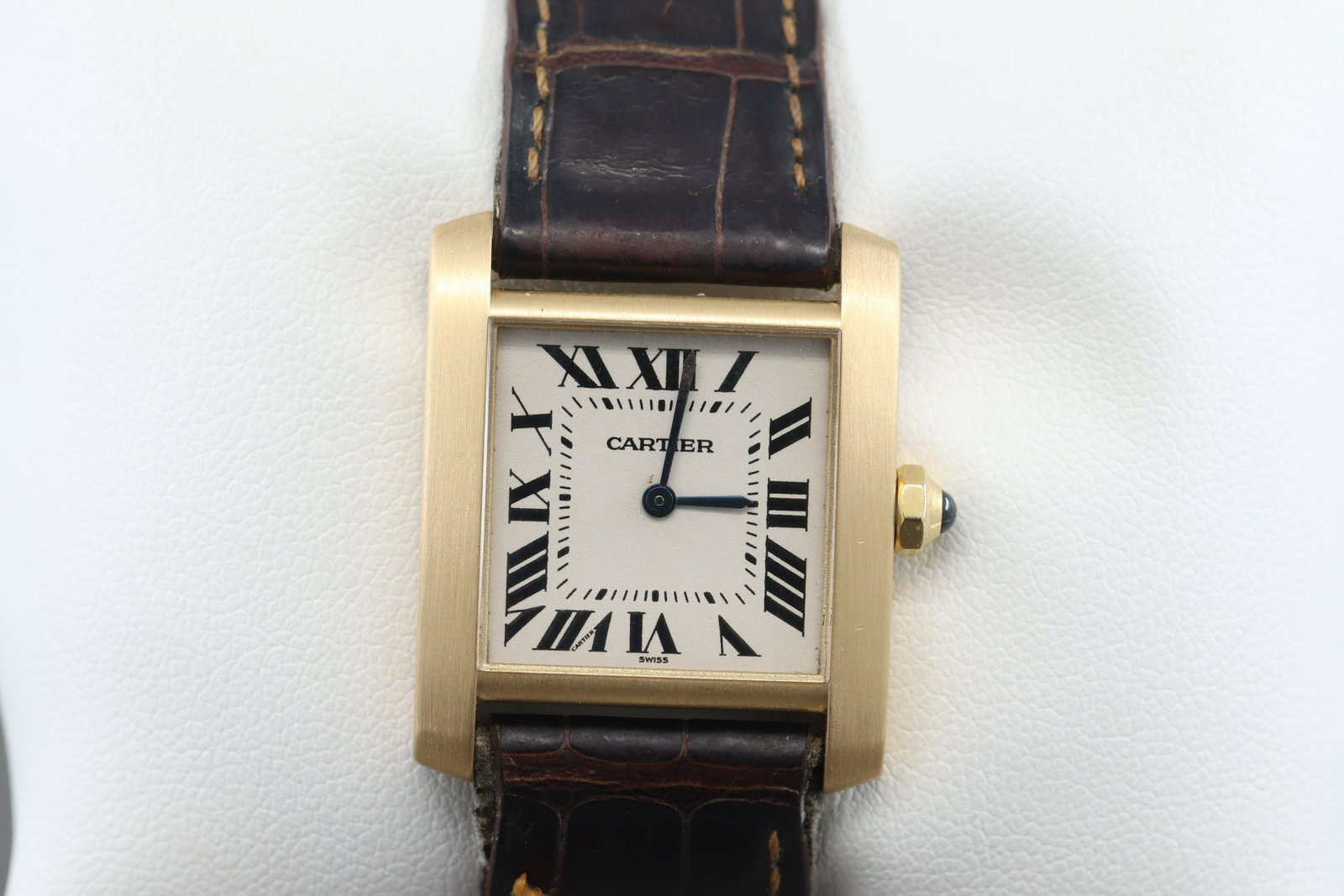 Cartier Tank Francaise Solid 18k Gold Ladies 1821 Watch: This lot is for a Cartier Tank Francaise 18k gold wristwatch. The watch features a white dial and black roman numeral markers with blue hands on a brown leather crocodile band. Contains a quartz batte