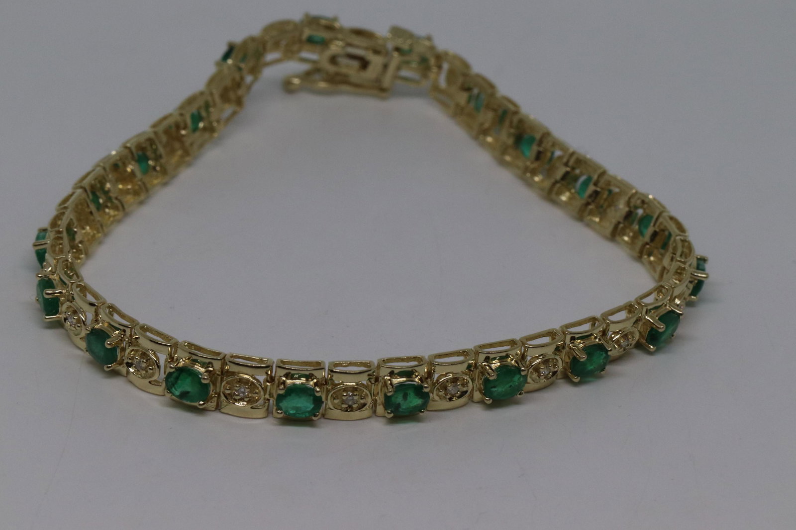 14Kt Emerald/Diamond Bracelet: A 14 karat yellow gold diamond bracelet with Emeralds. The bracelet has a total of 19 Oval Shapped Emeralds and has 20 Round brilliant diamonds. Bracelet measures 6.50in. Total weight of this gorgeous