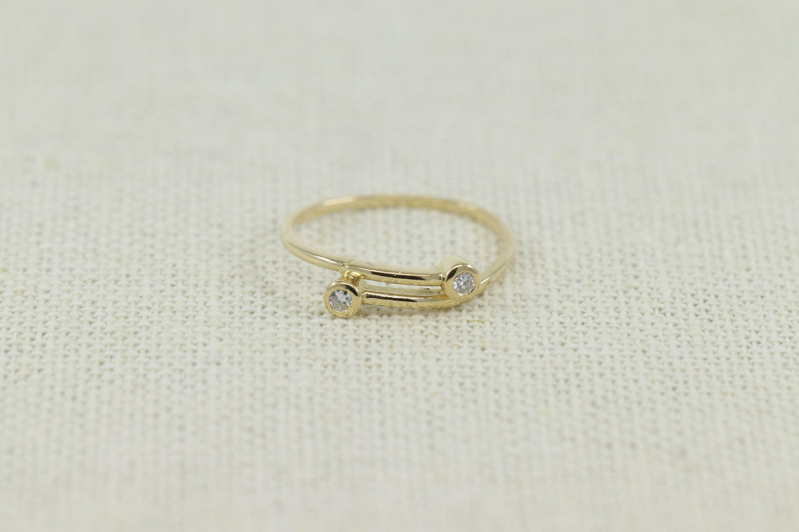 14KT Stackable Diamond Band: A beautiful modern 14kt Yellow Gold Diamond stackable band. The ring has a total of 2 round brilliant diamonds. The ring size is 6.00. SKU01IOSNCF4