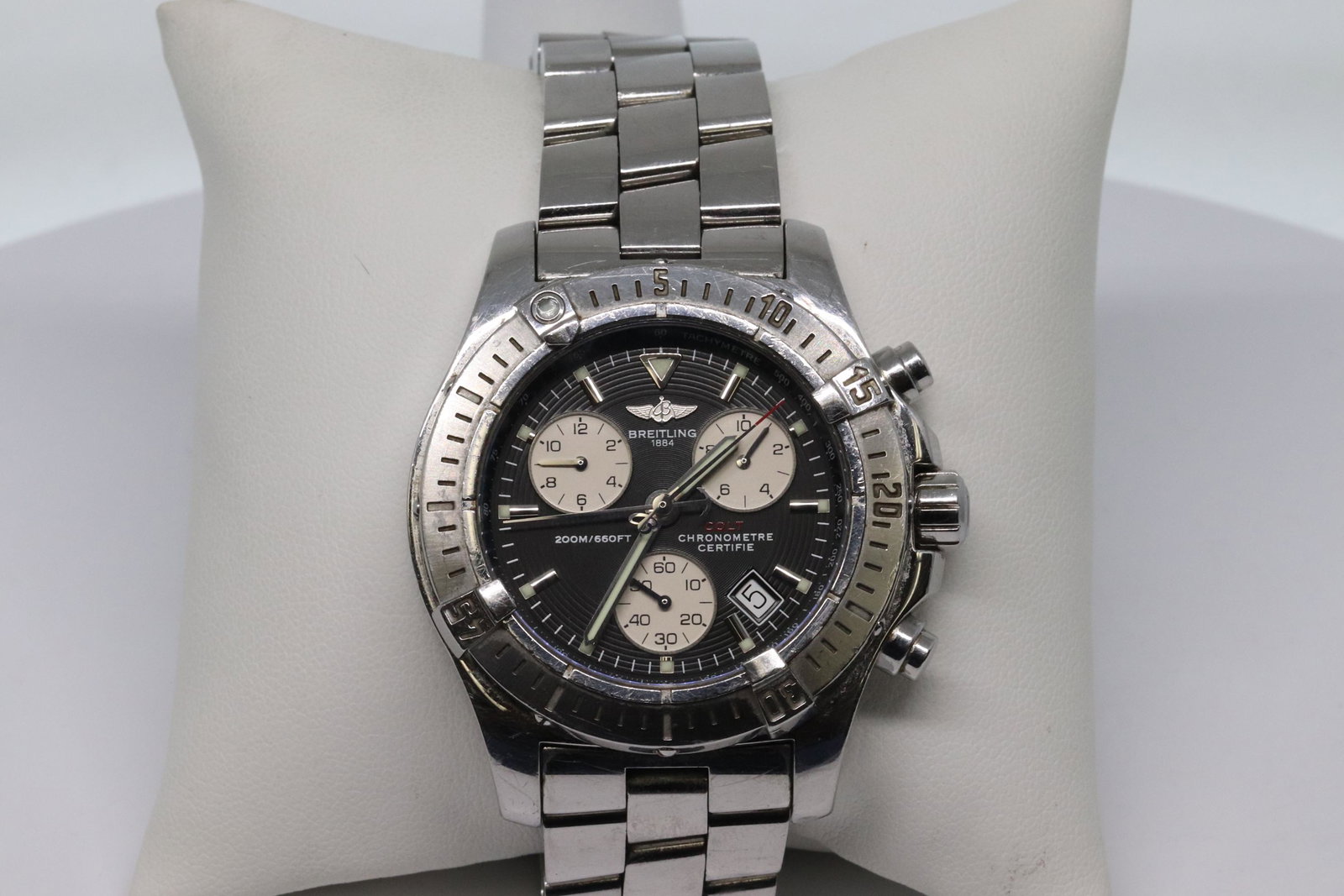 Breitling Colt Black Panda Dail Chronograph Steel: This is pre-owned Breitling Colt A73380 is a beautiful men's timepiece. The movement is cased in a stainless steel case. It has a round shape face, chronograph, date, small second subdial, tachymeter 