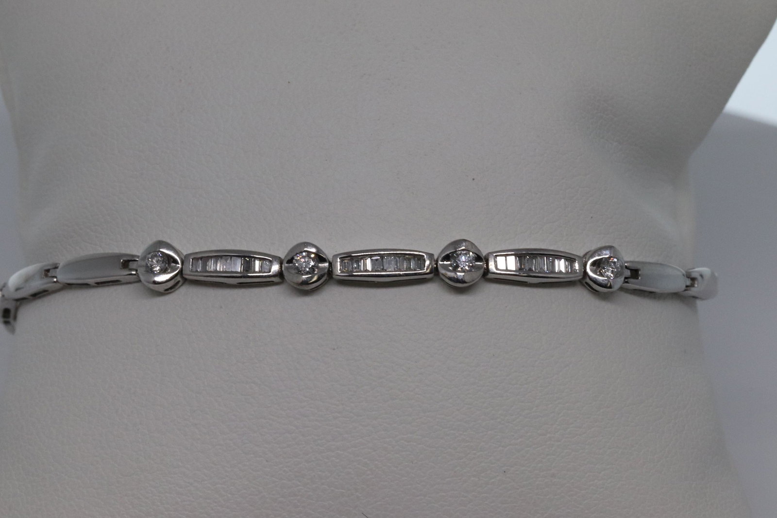 18Kt Diamond Bracelet: A 18kt white gold diamond bracelet. The bracelet has round and baguette shaped diamonds. The total weight of diamonds is approx 0.96tcw. Diamonds are VS1-Vs2 clarity. G-H Color. Bracelet length: 7.50i