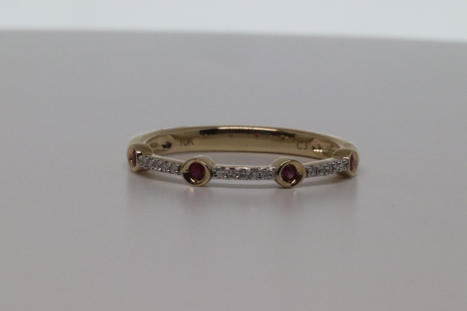 Bezel Set Pave Round Ruby & Diamond Ring.: Bezel Set Pave Round Ruby & Diamond 10k Yellow Gold Wedding Band Ring.Total Gem Weight:0.13 carats Total Diamond Weight:0.05 carats.Number Of Stones:22