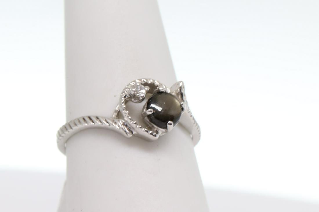10k Modern Diamond Ring: Beautiful 10k white gold diamond ring with Black tiger stone in the center. There is a diamond whichs weighs approx 0.02ct. Pre-owned in excellent condition. SKU:BOHD1D