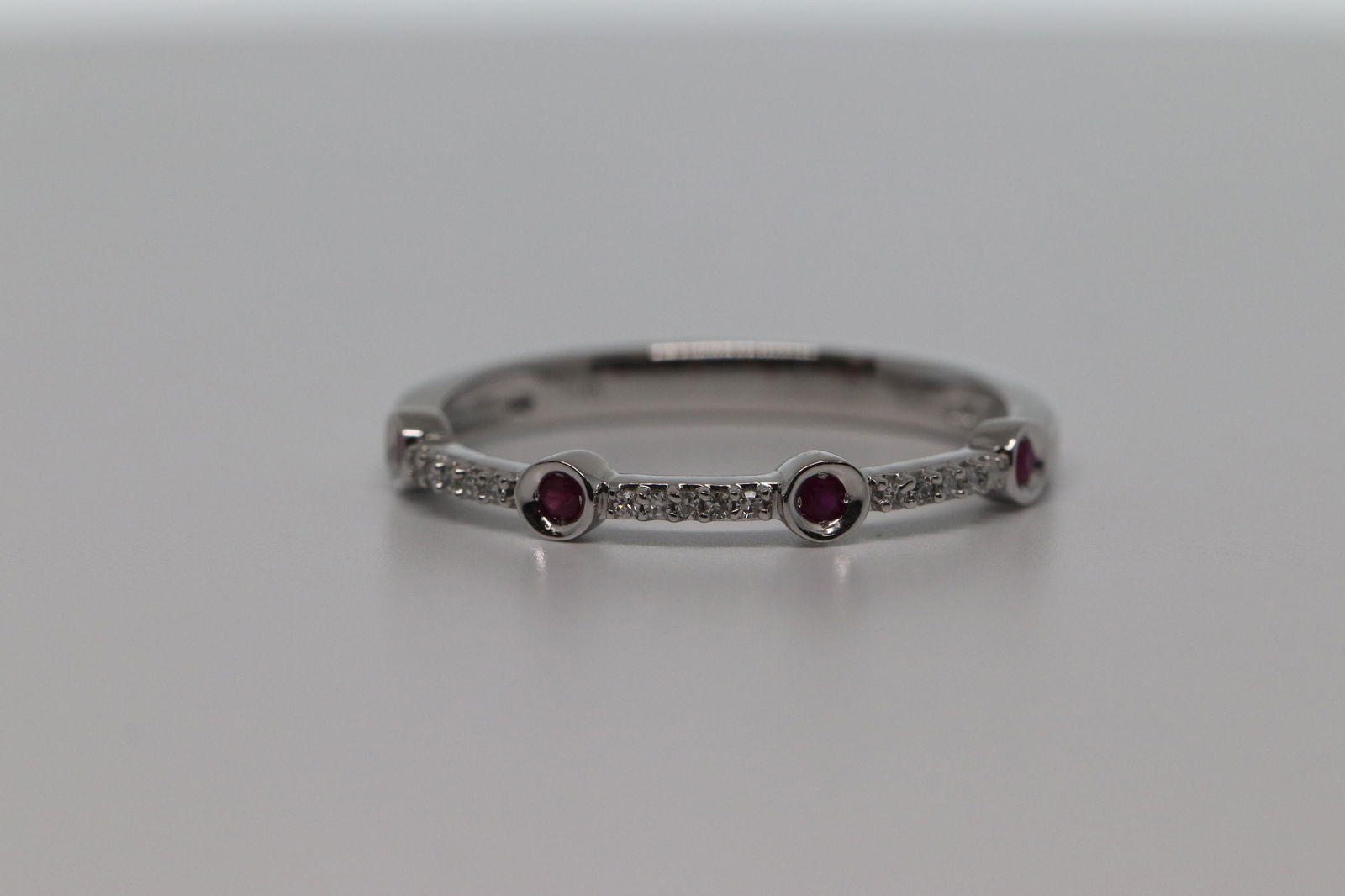 Bezel Set Pave Round Ruby & Diamond 10k White Gold: This is a Bezel Set Pave Round Ruby & Diamond 10k White Gold Ring.Total Gem Weight:0.13 carats Total Diamond Weight:0.05 carats. Number Of Stones:22. Ring Size:7.