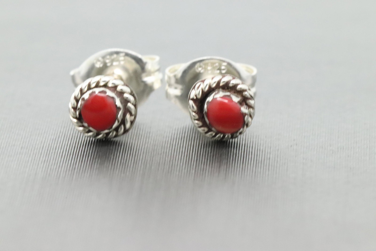 Zuni handmade Sterling Silver Earrings.: Sterling silver coral earring has twist wire and a mini hand cut stone, about 2mm. Zuni handmade by Serena Sanchez.