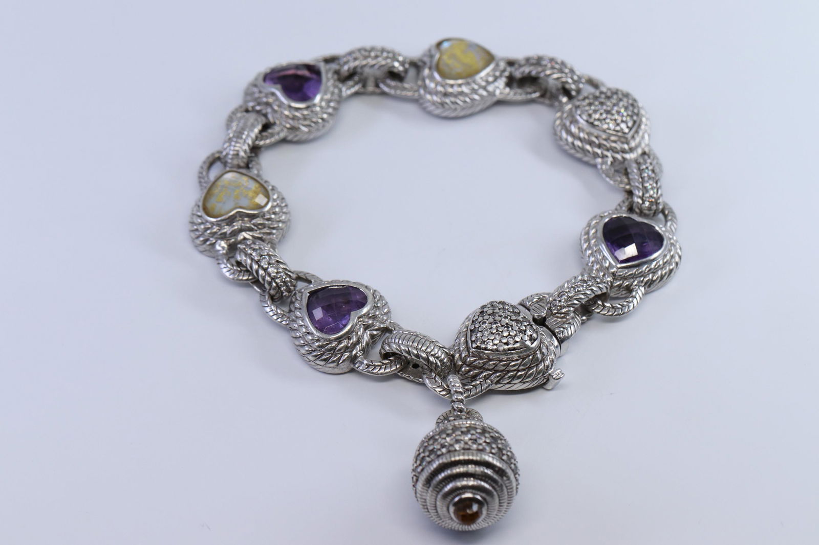 Sterling Silver JUDITH RIPKA DIAMONIQUE HEART Amethyst: This Is A Sterling Silver JUDITH RIPKA DIAMONIQUE HEART Amethyst BRACELET. Bracelet Total weight is 62.10g.