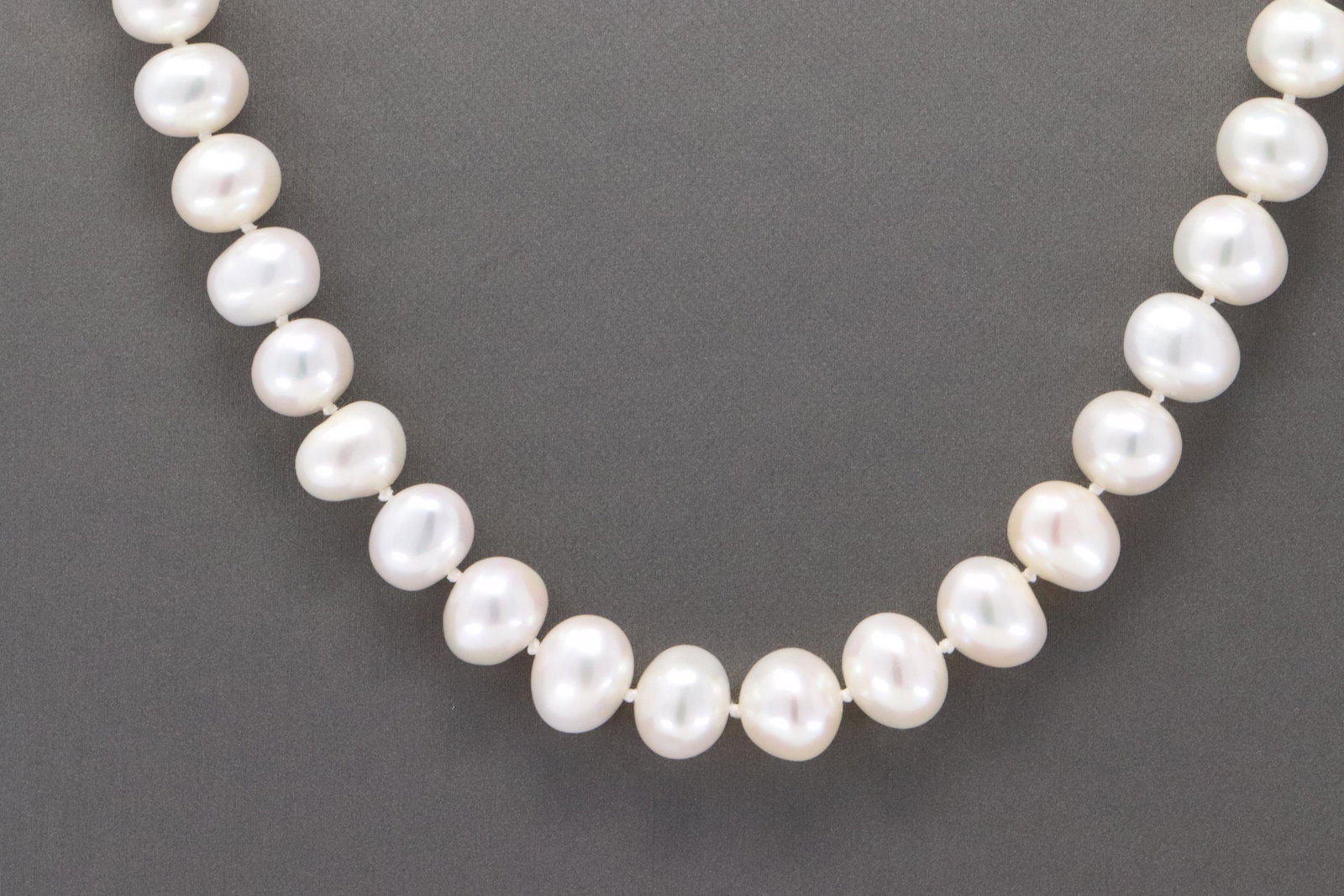 Ladies Pearl Necklace: A ladies 20.00" long white fresh water Pearls. There are a total of 45 Pearls. The clasp is .925 with a small Pearl on the center.