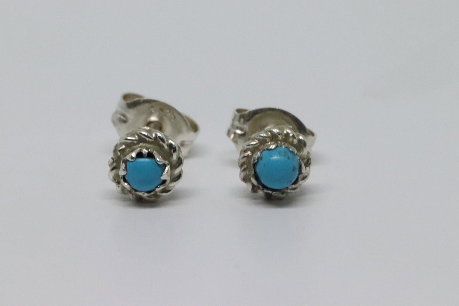 turquoise post stud with twist wire: turquoise post stud with twist wire. It measures just over 3/16" in diameter. It is Navajo hand made by Michael Bitsie