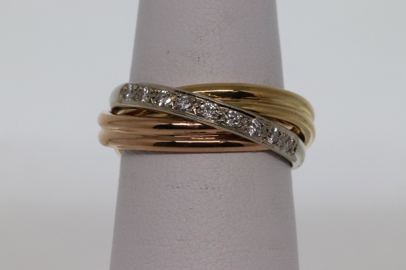 18Kt Diamond Ring: A Gorgeous 3 Tone 18Kt Yellow Gold Diamond ring. The rings design is is inspired by "Cartier". The ring is White, Rose and Yellow Gold. There are a total of 9 Round Brilliant Diamonds. The diamonds we