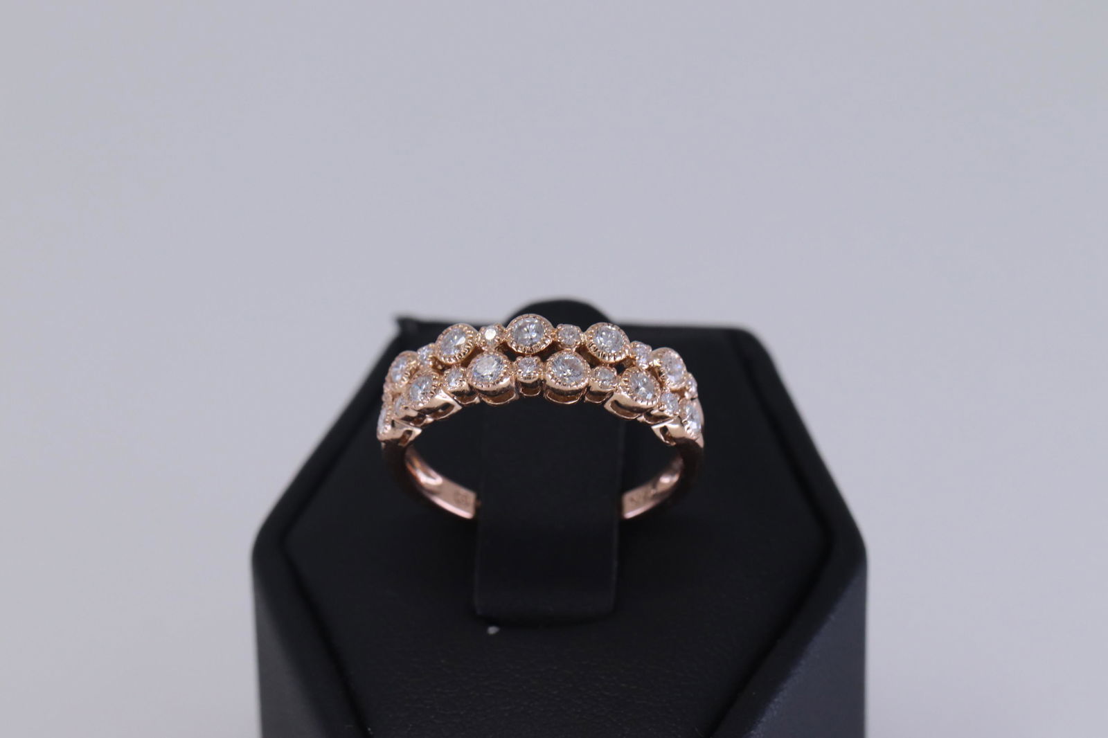 14Kt Rose Gold Diamond Ring: A ladies Modern 14kt Rose Gold Diamond Ring. The rings are 2 attached. Style: stackable rings. Total diamonds: 22 round brilliant diamonds. The diamond weight approx: 0.75cttw. Ring size: 7.00. SKU: B