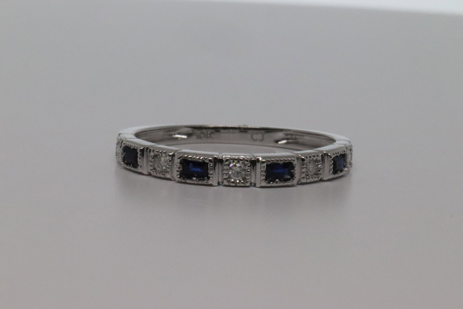 1/3cttw Baguette Sapphire & Round DiamondÂ Ring.: 1/3cttw Baguette Sapphire & Round Diamond 10k Gold Milgrain Wedding Band Ring. Total Gem Weight:0.33 carats Total Diamond Weight:0.07 carats Number Of Stones:9 GEMSTONE INFORMATION Stone:Sapphire Shap
