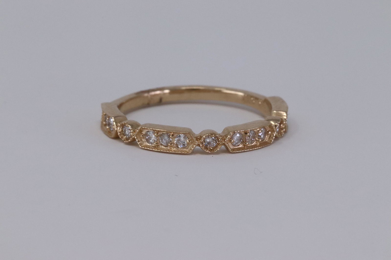 Round Diamond 14k Yellow Gold Stackable ring: A ladies 14kt Yellow Gold Diamond stackable ring. Ring has a total of 15 round brilliant diamonds. The diamonds weight 0.25cttw. Ring size: 6.50.