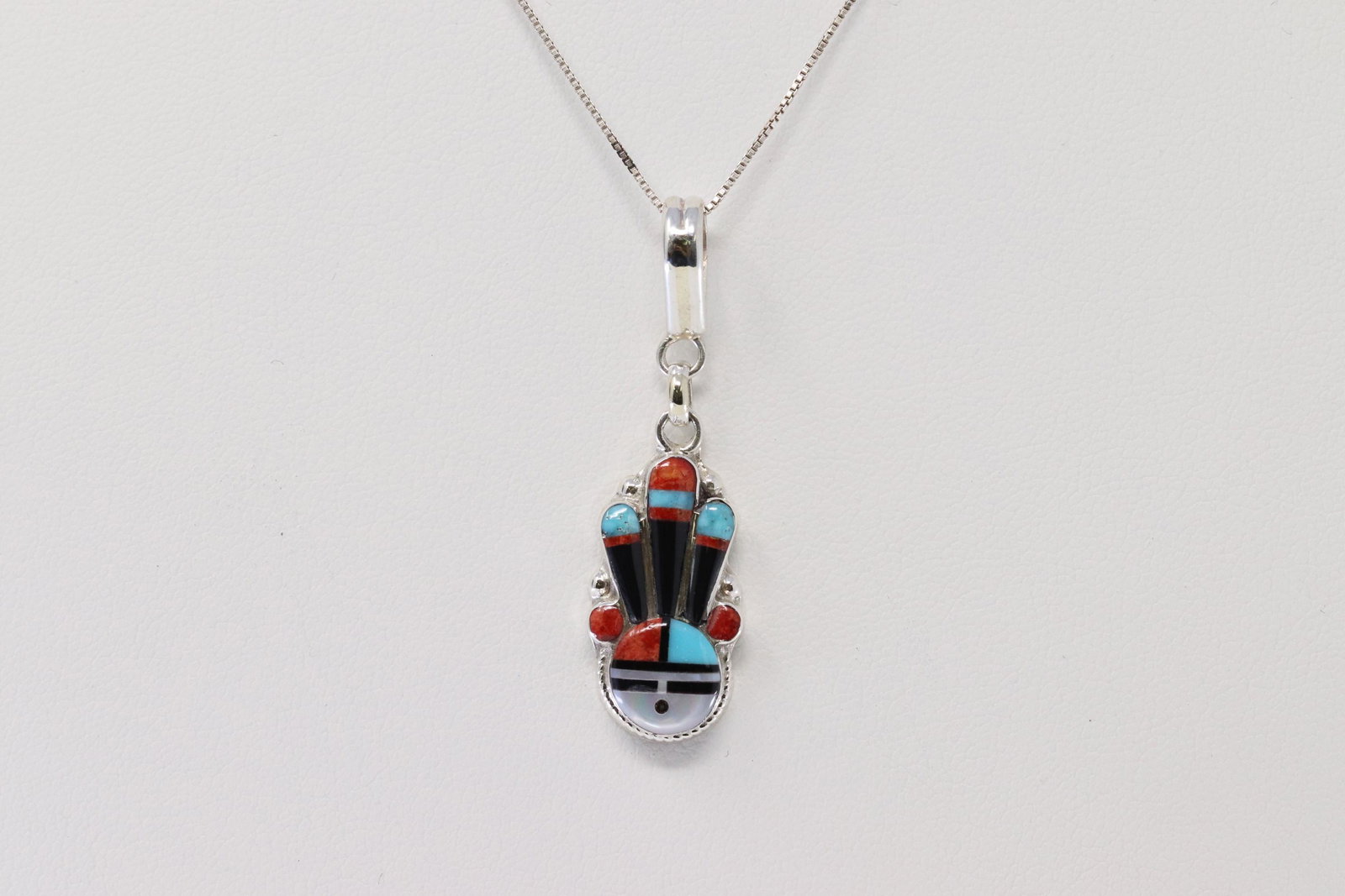 Sterling Silver Zuni Pendanr/Necklace.: This is a Sterling silver, traditional color inlay sunface pendant. It measures approximately 2 5/8" long including bail by 1/2" wide at widest. It is Zuni hand made and inlaid by Ruth Lonjose. The ne