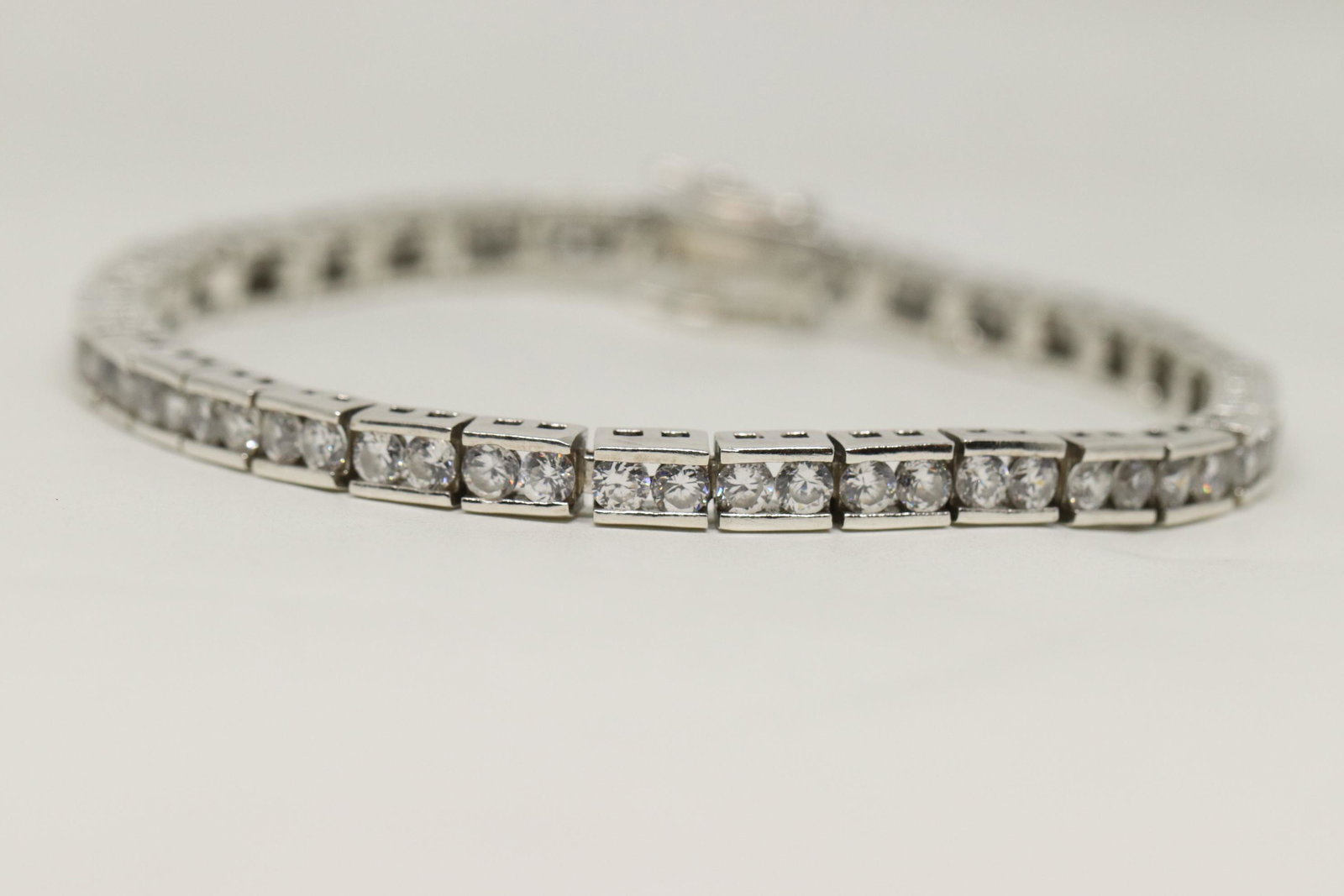 925 Silver Tennis Bracelet: This is a 925 Silver Tennis Bracelet. This bracelet has white cz stone all around. Bracelet total weight is 21.70g.
