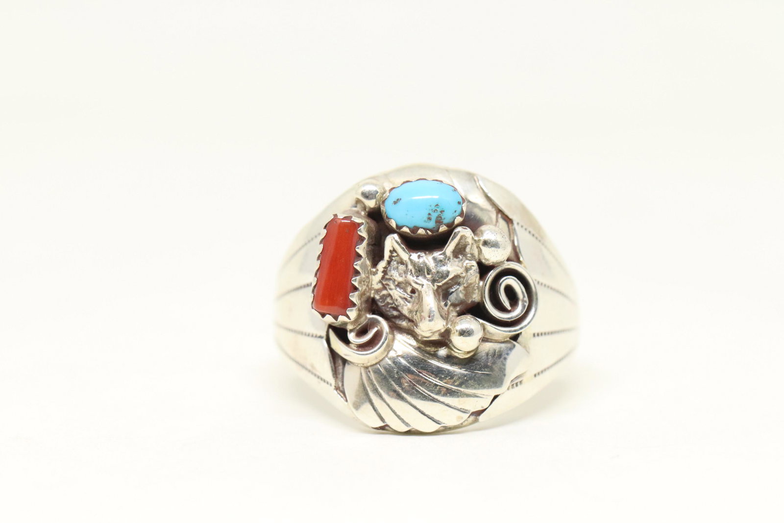 Navajo Handmade Sterling Silver Turquoise And Coral: This is a Navajo Handmade Sterling Silver Turquoise And Coral Wolf Ring. Ring size is 11.00