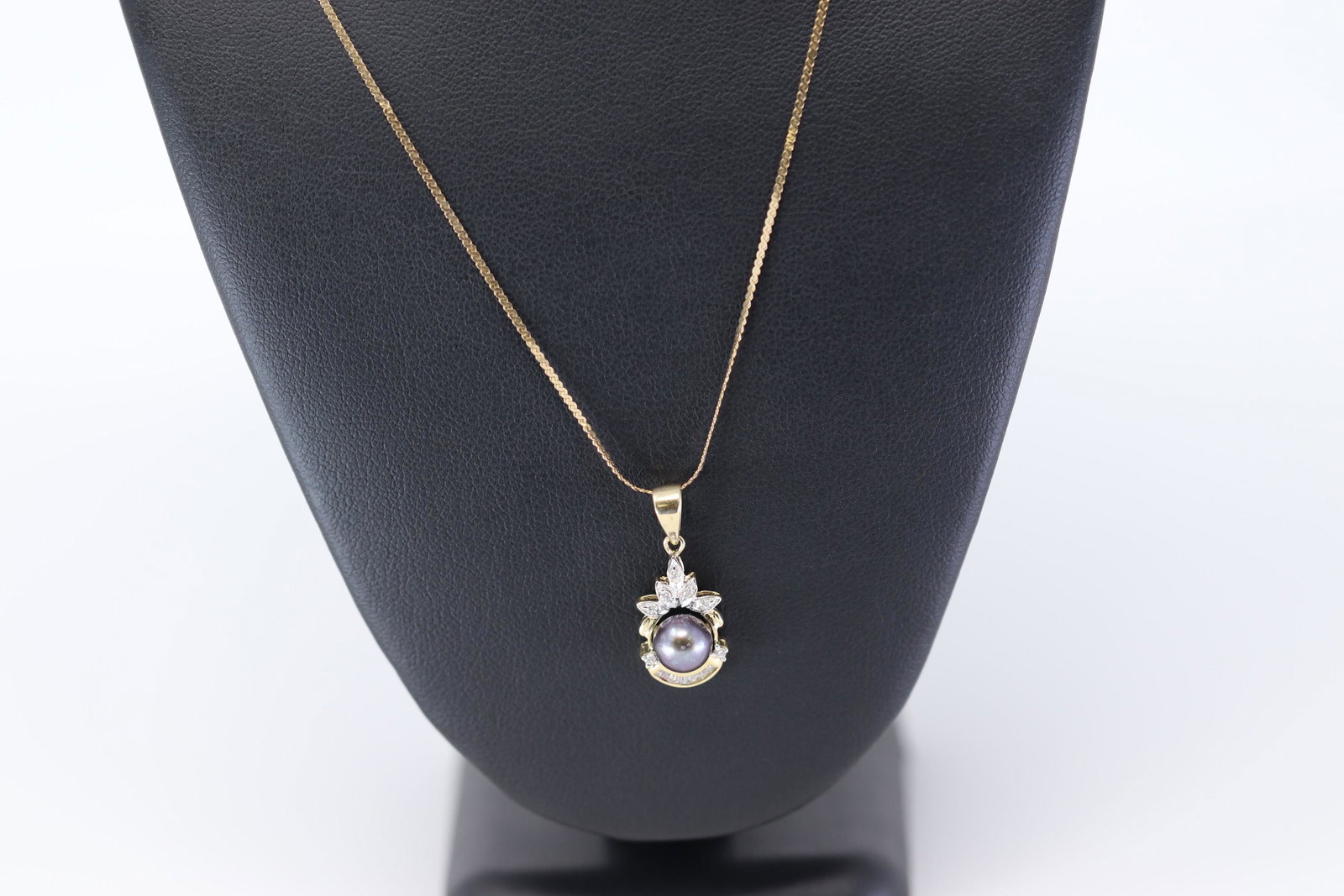 14K Diamond Charm w/ Black Pearl: A ladies 14kt Yellow Gold Diamond charm with a Black Pearl in the center. The diamonds weigh approx 0.25cttw. Necklace length: 18.00in. SKU: CJD3SF