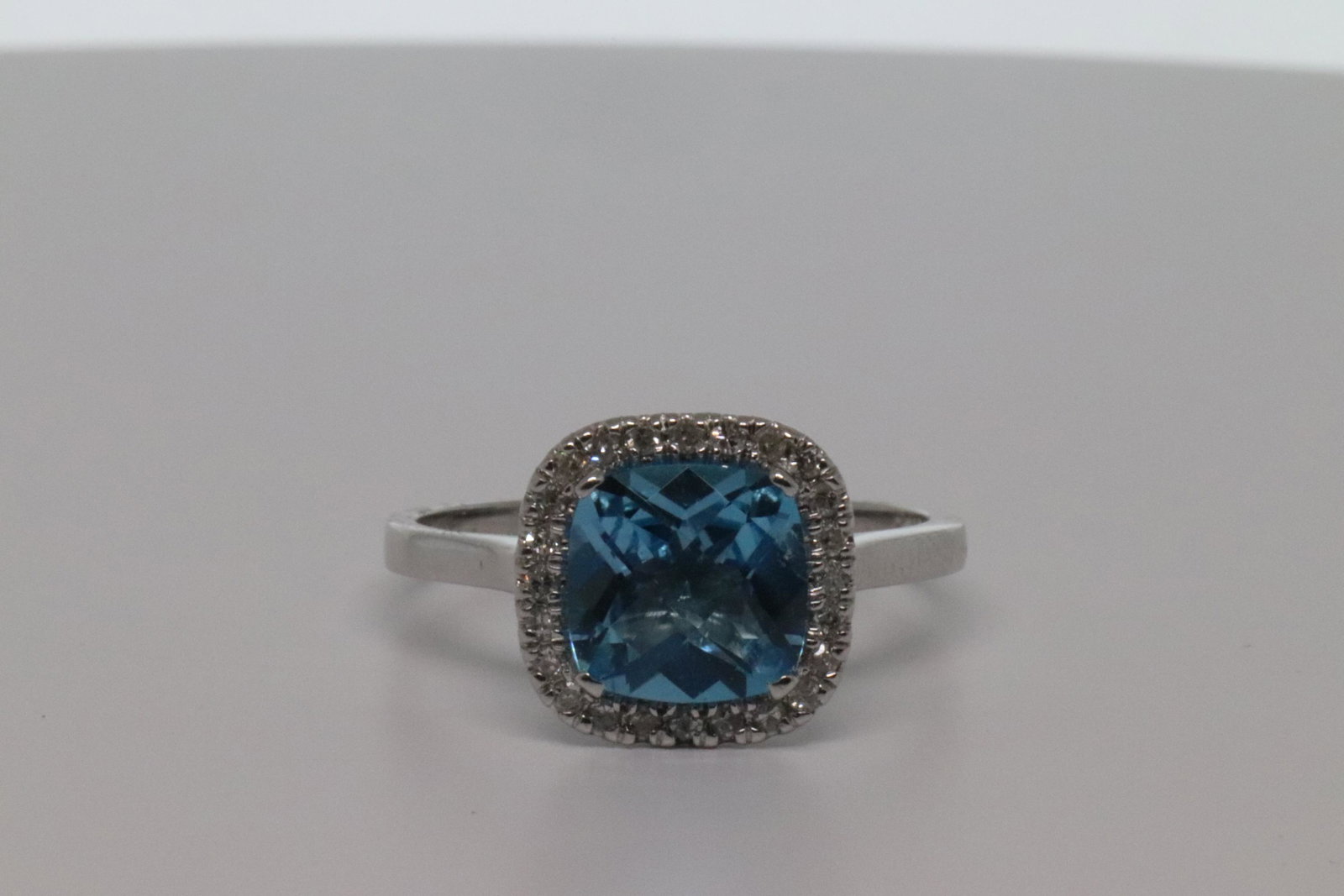 14Kt Ladies Diamond Ring: Ladies 2.55ct Cushion Blue Topaz & Pave Diamond 14k White Gold Halo Solitaire Ring. Ring size 7.50. Total Gem Weight: 2.40 carats. Total Diamond Weight: 0.15 carats. Setting Type:Pave/Prong. GEMSTONE 