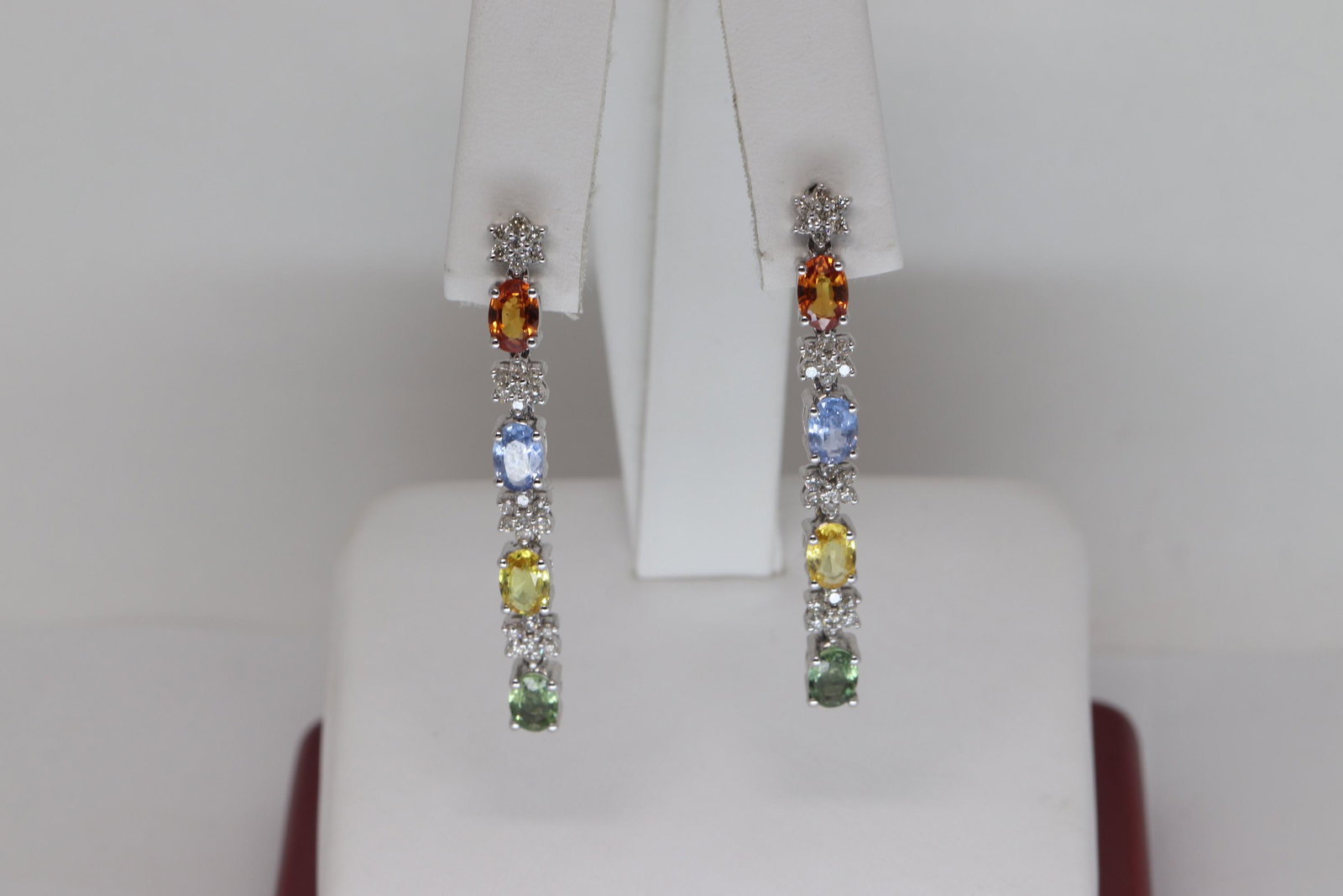 14Kt Diamond Earrings/ Citrine, Garnet, Peridote and: A ladies 14Kt White Gold Diamond Earrings. The earrings has a oval shape Garnet, Citrine, Tanzanite, and Peridote stones. The earrings has a total of 56 round brilliant diamonds. The diamonds are VS1-