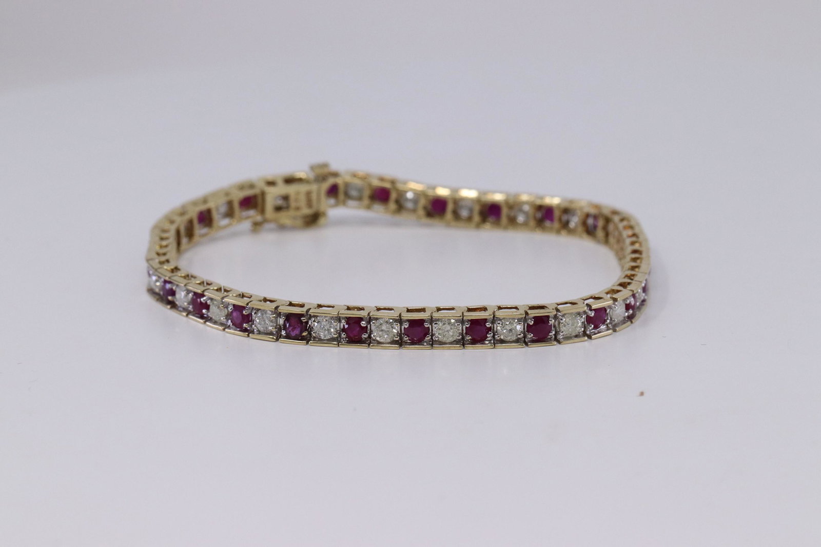 Ladies Diamond & Ruby Bracelet: This is a Ladies Yellow Gold Diamond bracelet with Round Ruby's. There are a total of 25 round brilliant diamonds and 25 round Red Ruby's. Total stone weighs: 5.00cttw. Length: 7.50. Total weight: 11.