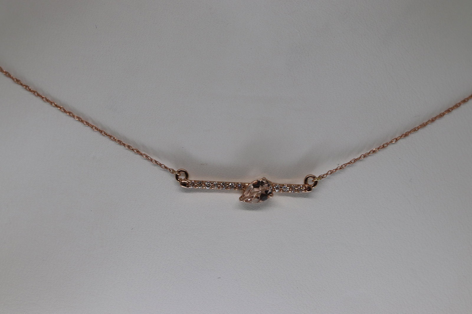 1/2ct Pear Morganite & Diamond 14k Rose Gold Bar: This is a 1/2ct Pear Morganite & Diamond 14k Rose Gold Bar Pendant Necklace.Stone:Diamond Shape:round.Total Diamond Weight:0.10 carats.Stone:Morganite Shape:Pear Carat:0.40 carats Color:Peach. Chain L