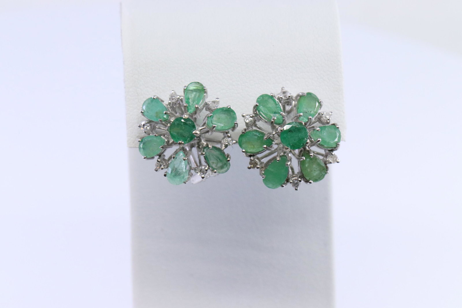 Art Deco Diamond | Emerald Earrings | Palladium: A Ladies Palladium Art Deco Diamond & Emerald earrings. These earrings has a total of 12 round brilliant diamonds and 14 Emerald stones set around and on the center of the earrings. Backing: French ba