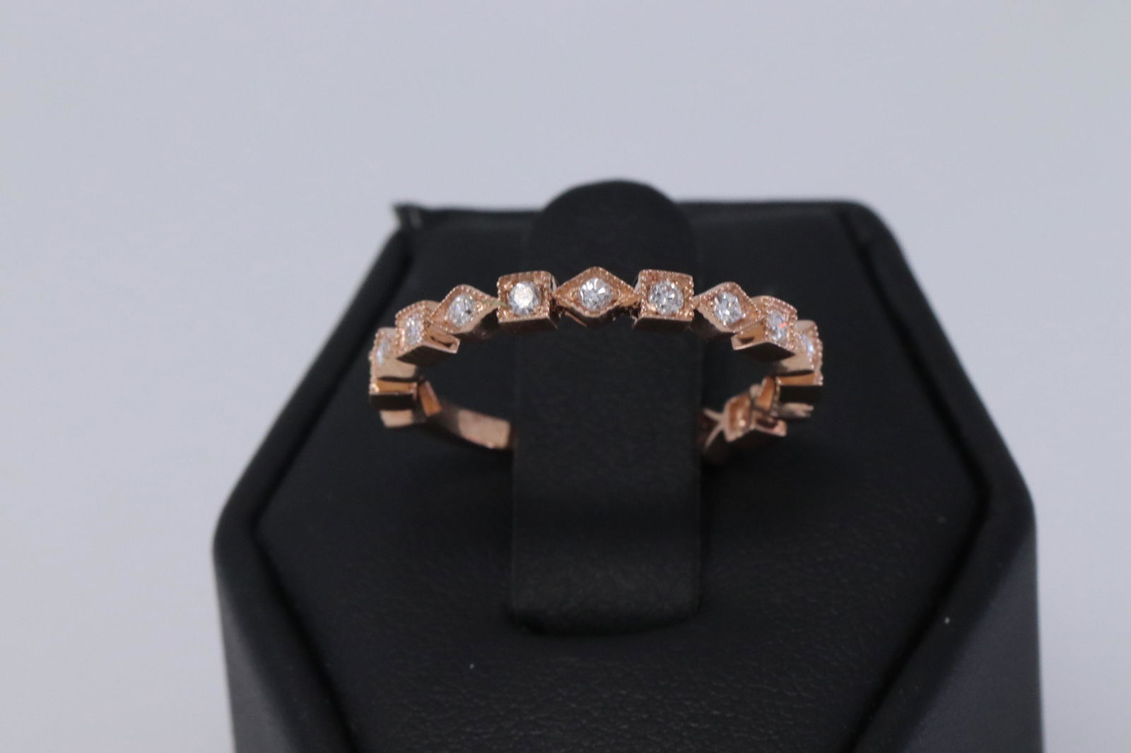 14KT Rose Gold stackable Diamond Ring: A ladies 14kt Rose Gold Diamond stackable ring. The ring has a total of 15 round brilliant diamonds. The diamonds weight 0.25cttw. Ring size: 7.00.