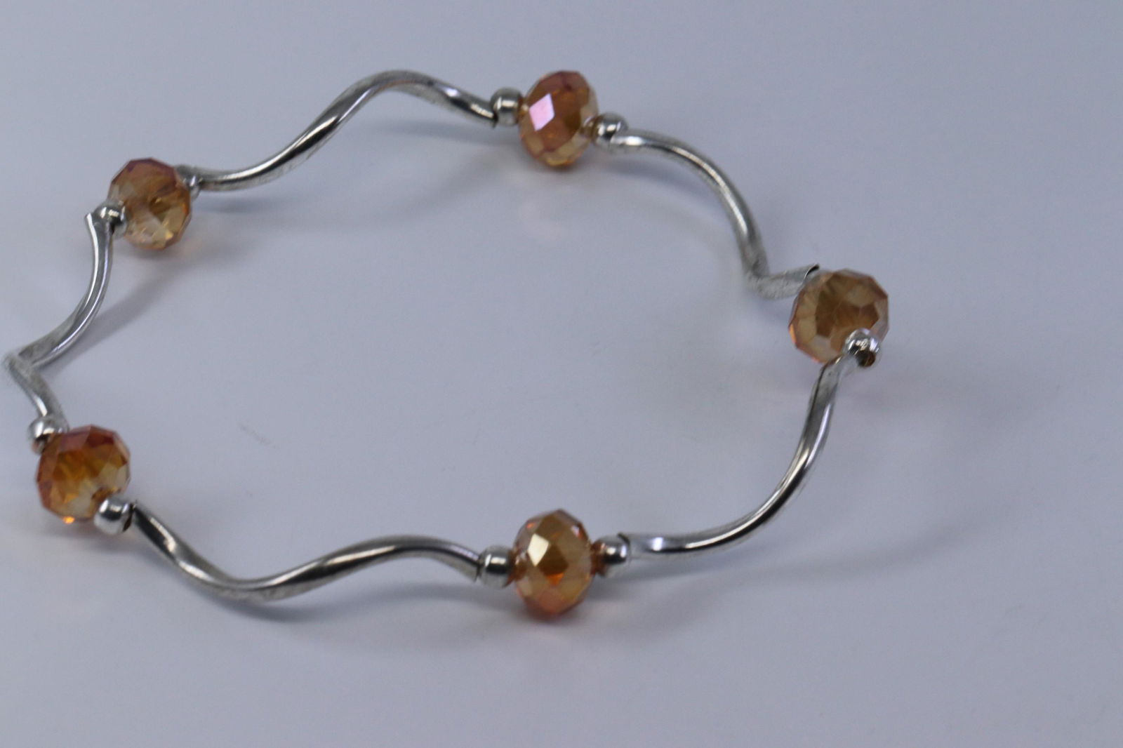 .925 Silver Bead Bracelet: A ladies .925 silver bead bracelet. Bracelet has rubber string. Size: 7.00-8.00". Total weight: 3.80 grams.