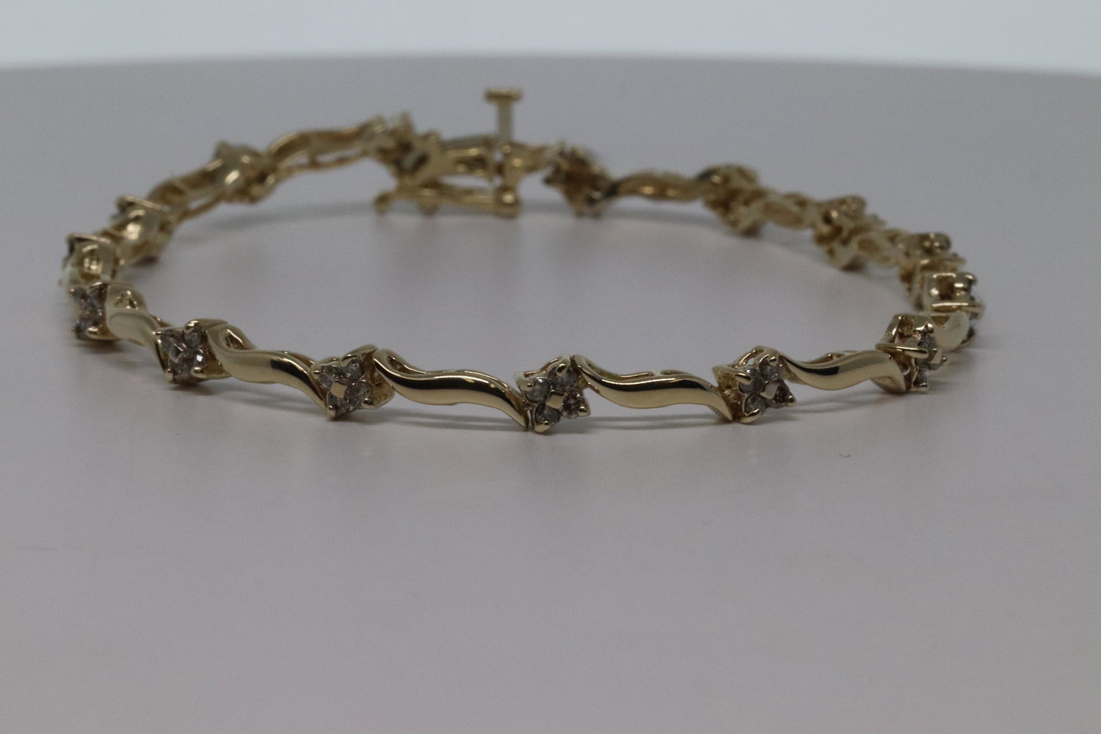 14k Diamond Bracelet: Ladies 14 karat yellow gold diamond bracelet. The bracelet has a total of 60 round diamonds. The diamonds weight approx 0.75-1.00tcw. The total weight of the bracelet is 7.6g.