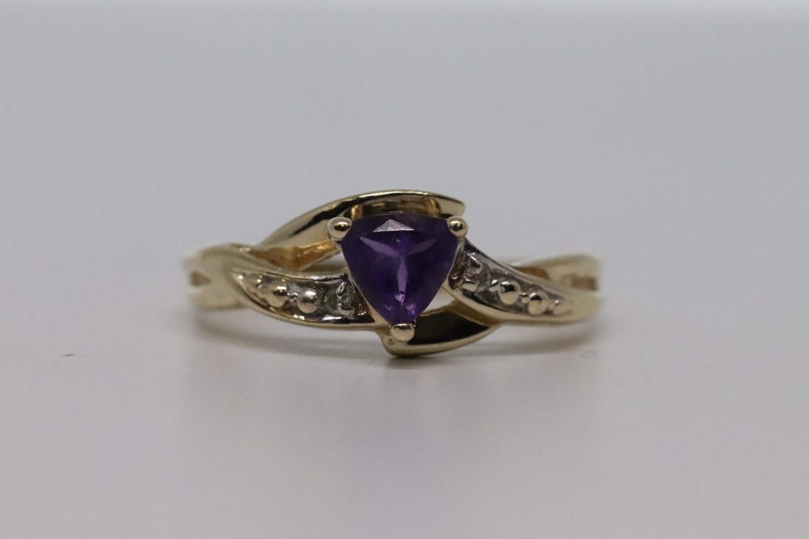 Amethyst & Diamond Ring: 14k Yellow gold diamond ring with a Trianguler Amethyst in the center. The ring size is 5.75 and weights 1.9g