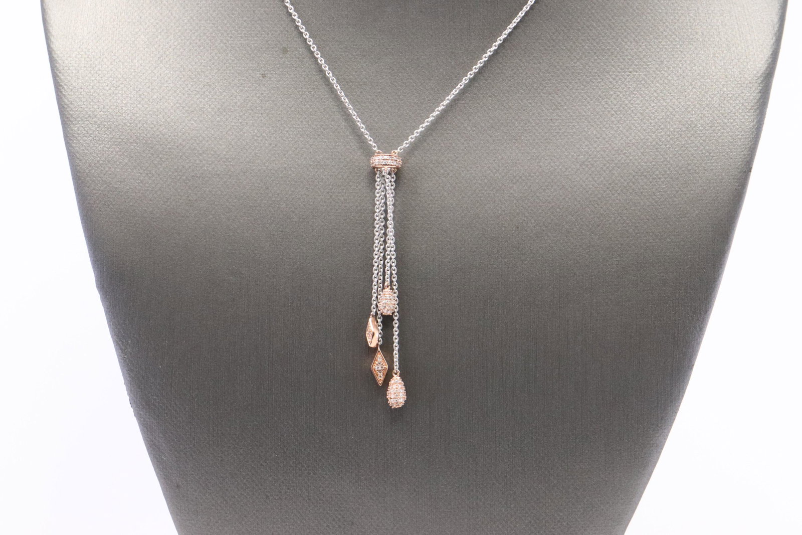 White / Rose Gold Diamond Necklace: A ladies White/Rose Gold Diamond necklace. This Tassel design necklace has round diamonds weighting 0.40ctw. Necklace length: 20.00in. SKU: OD-VMEET