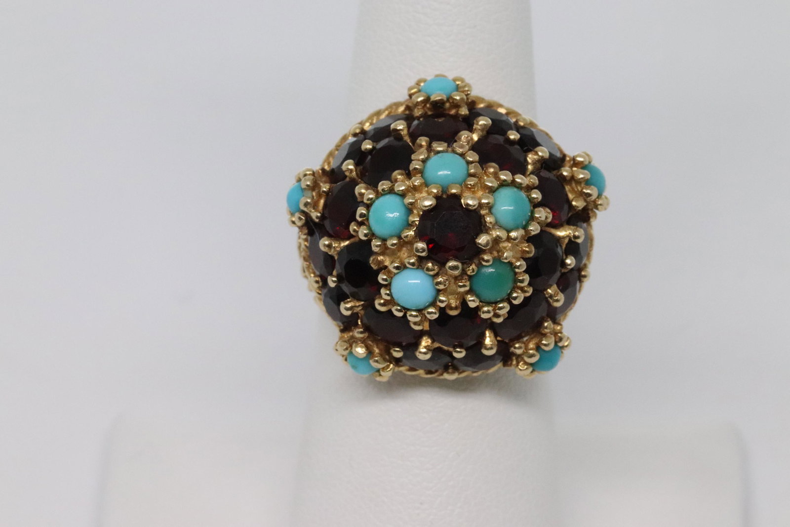 14kt Art Deco ring: Beautiful 14kt yellow gold Art Deco Ring. The ring has round Garnet stones and Turquoise stone. The ring size is: 7.00. Total weight: 16.90g. Free ring size upon winners request.