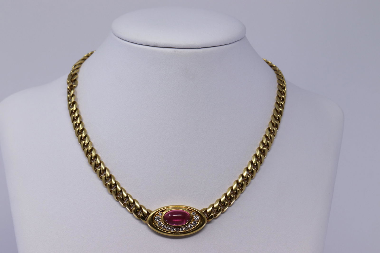 18Kt Bvlgari Diamond & Tourmaline Necklace: 18kt Yellow Gold Diamond Necklace. Necklace has a Pink Tourmaline stone in the center and round brilliant diamonds set under center stone. Diamonds weight approx 0.50-0.75ctw. Center stone measures: 1