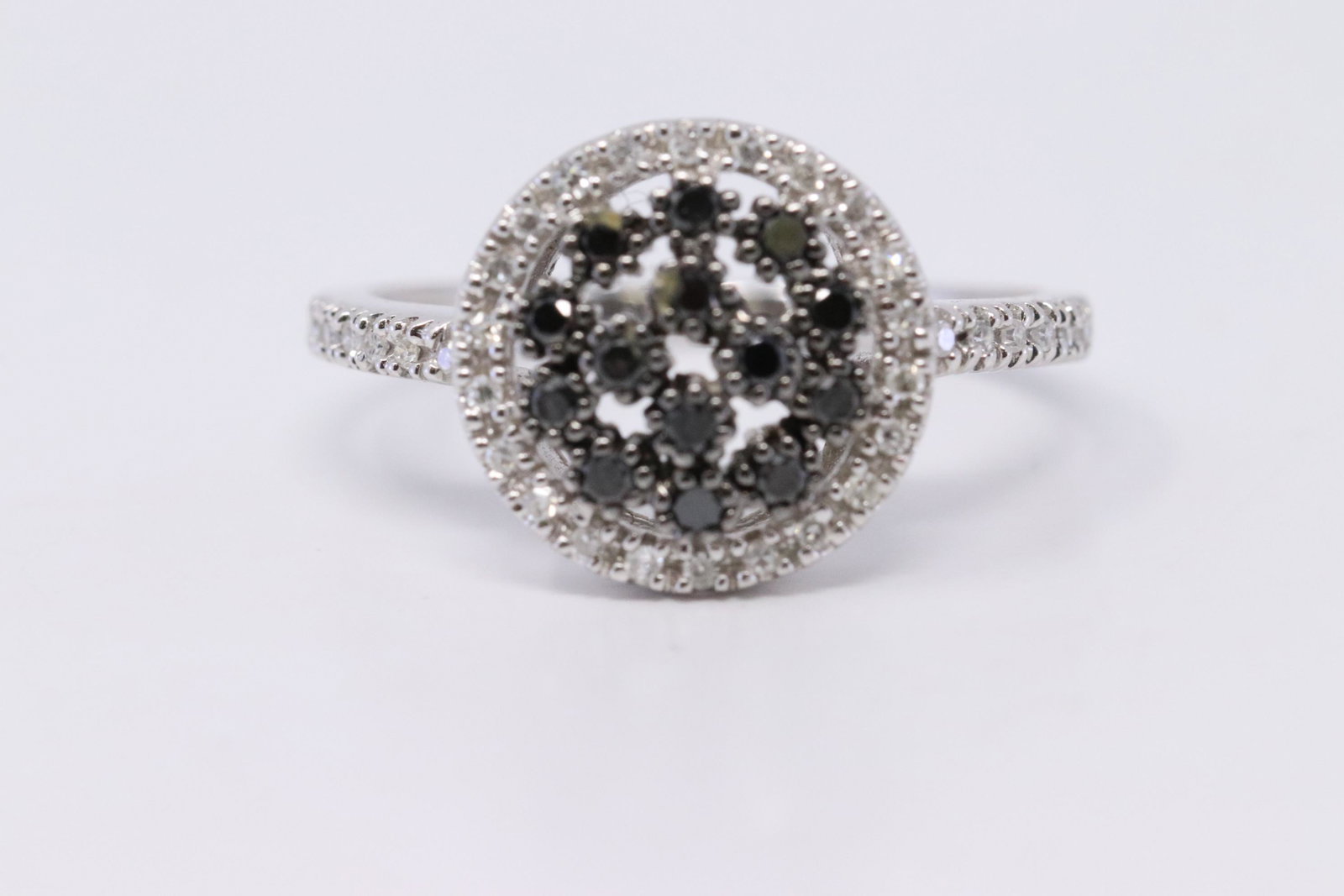 14Kt Modern Diamond Ring: A Modern 14kt White Gold Diamond ring. Ring has black and white diamonds. Diamonds weight approx 0.50ctw. Ring size: 7.00. Total weight 2.90 grams. AY-RI3NG1