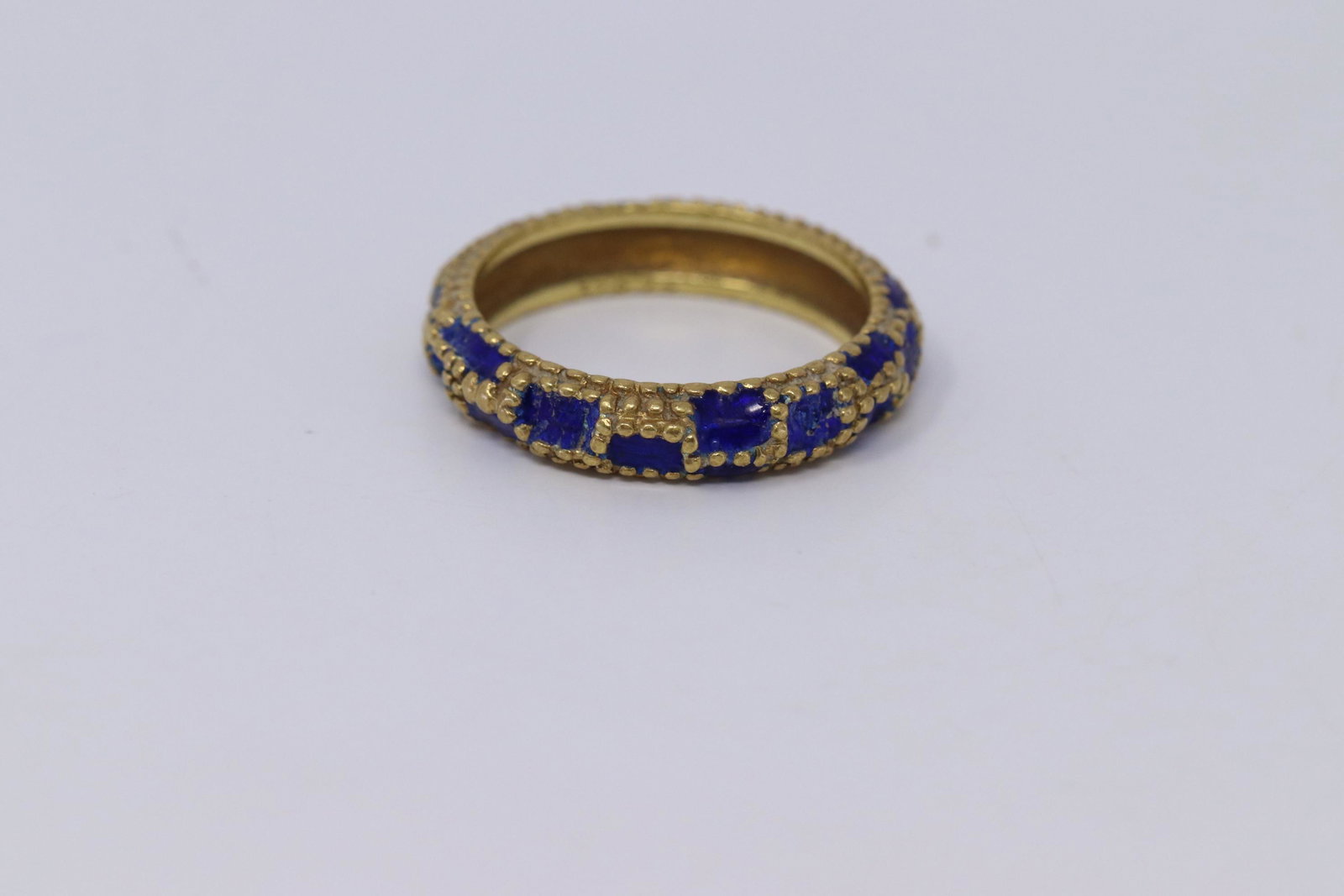 18Kt Cartier Blue Enamel Vintage Circ. 1960's: A Vintage 18kt Cartier Ring with Blue Enamel. Ring is market inside Cartier 18kt. This Finely crafted in 18kt Yellow Gold with Checkered Blue Enamel design. Beaded details. Size: 6.00.Width: 4.28mm. F