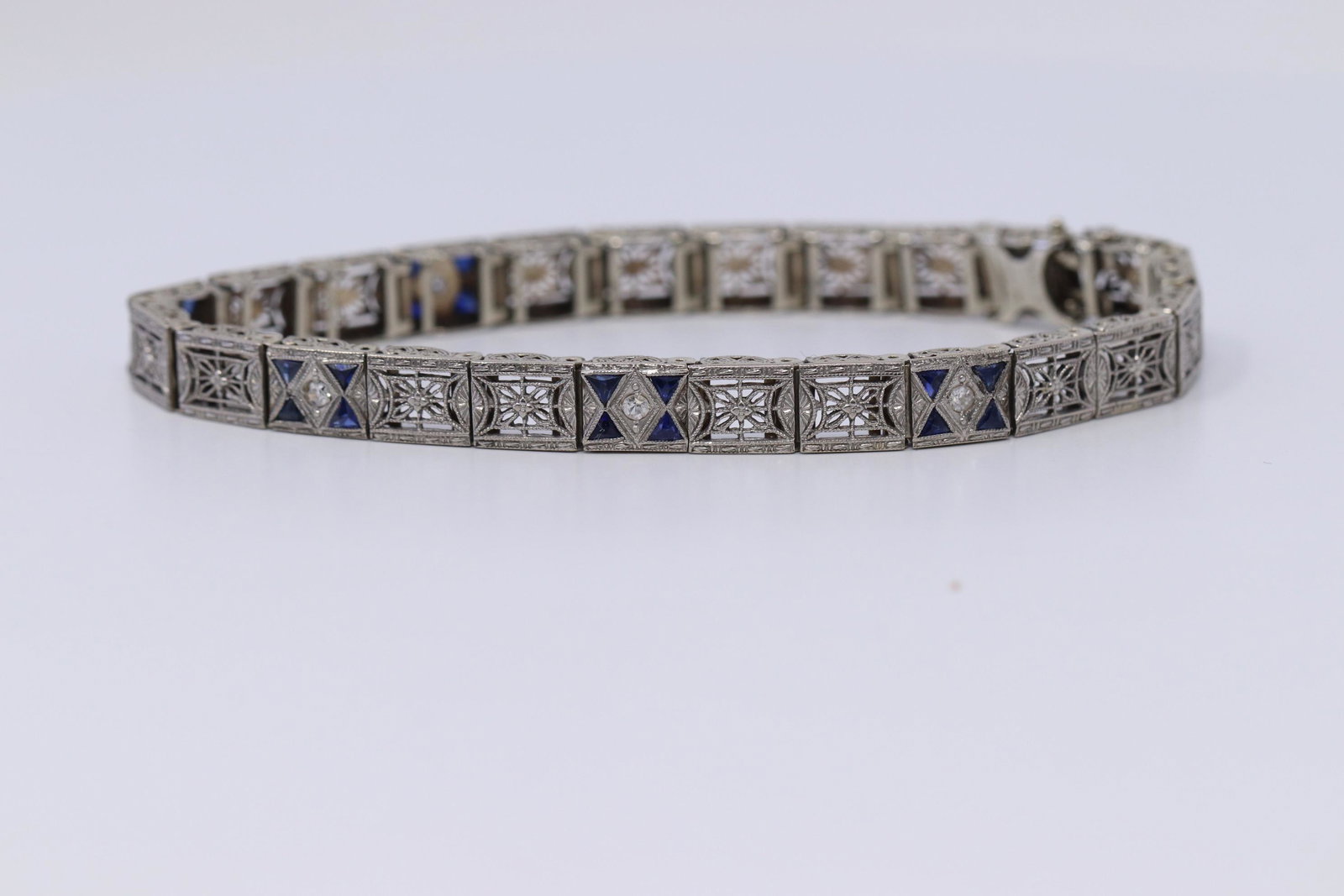 Platinum/14Kt Antique Edwardian Foliate Filigree: 14KT/ Platinum Antique Edwardian Foliate Filigree Diamond & Blue Sapphire Triangular cut. This beautiful antique bracelet has 20 Triangular French Cut Blue Sapphires and 5 Round Diamonds. Bracelet len